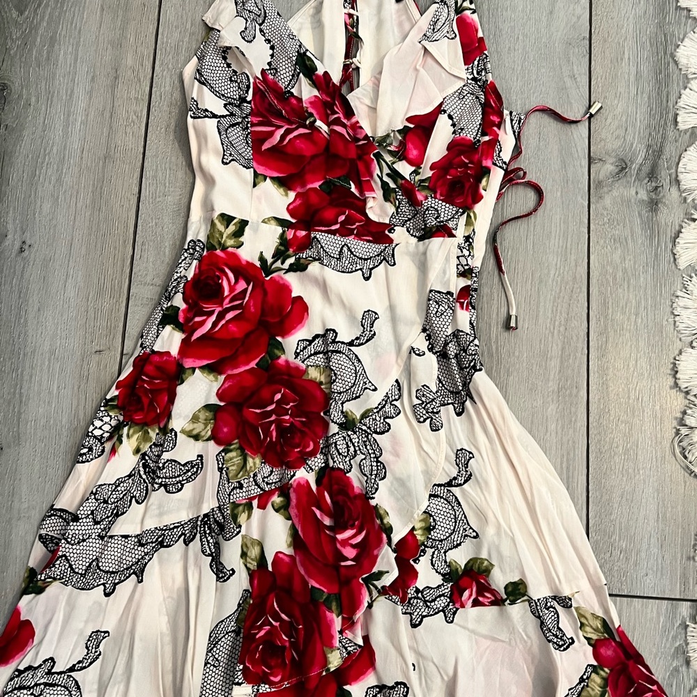 Ivory floral dress with crisscross tie back.